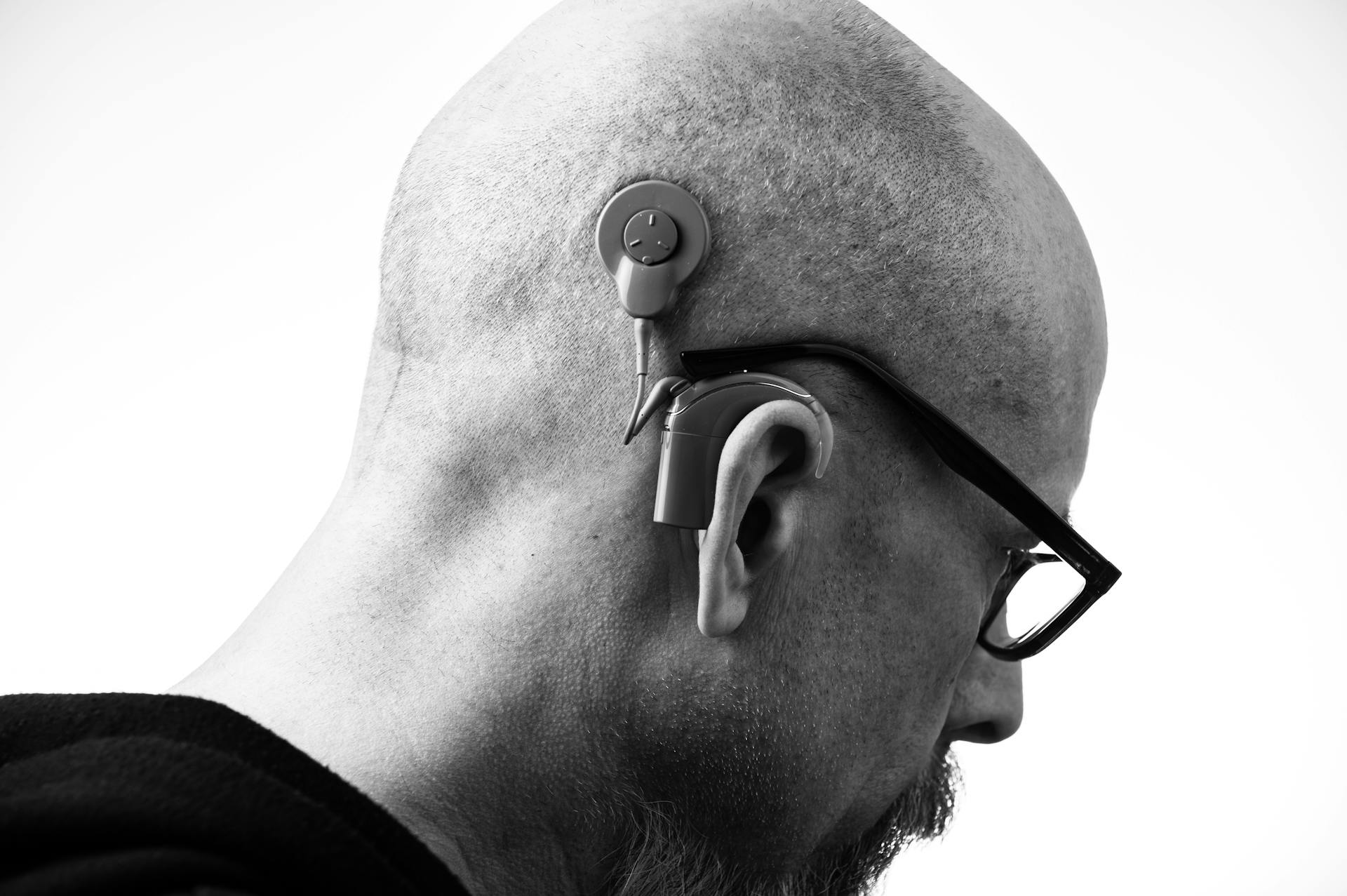 Discreet modern hearing aid resting on a neutral surface