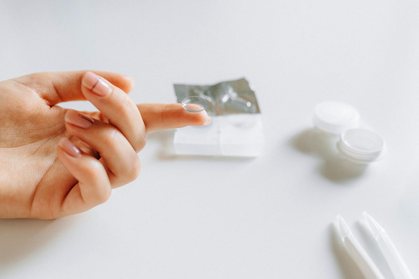 Soft contact lens resting on a fingertip
